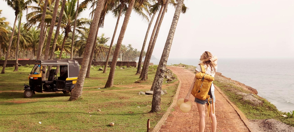 A woman enjoying fresh breeze at a Kerala beach