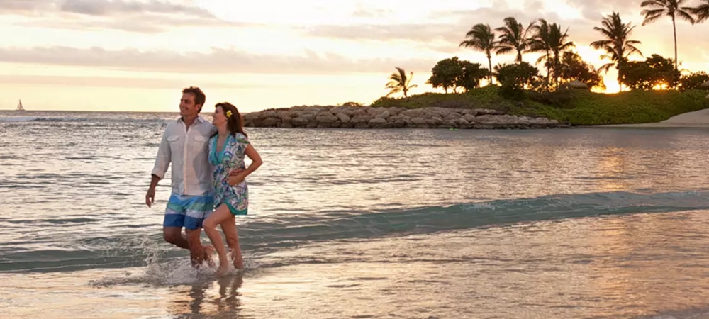 Couple walking by the beach in comfortable clothing