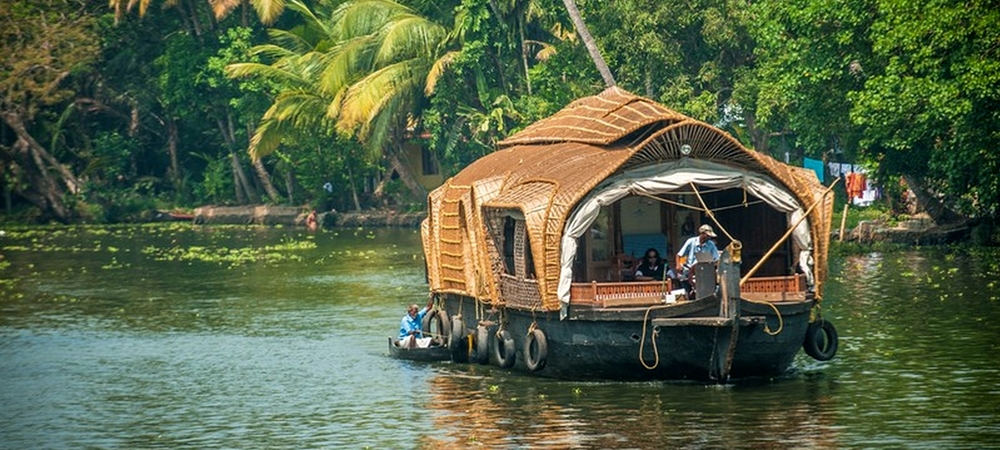 A houseboat cruising though the serene backwaters in Alleppey
