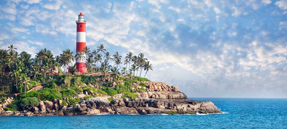 The picturesque red and white lighthouse at the Kovalam Beach