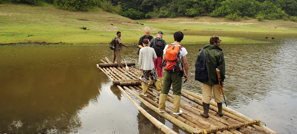 A group of travelers getting on their bamboo ride