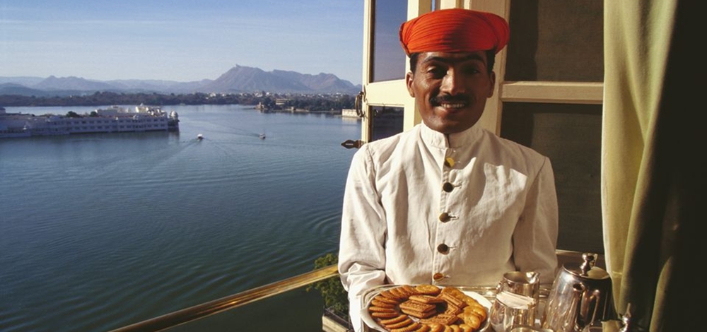 Indian waiter serving at a restaurant near the sea