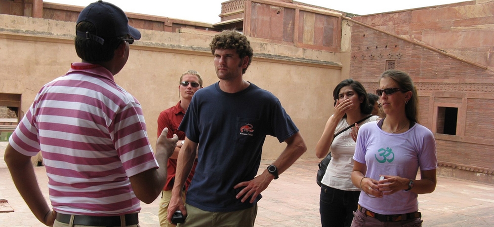 A tourist guide describing about a fort to a group of foreign tourists