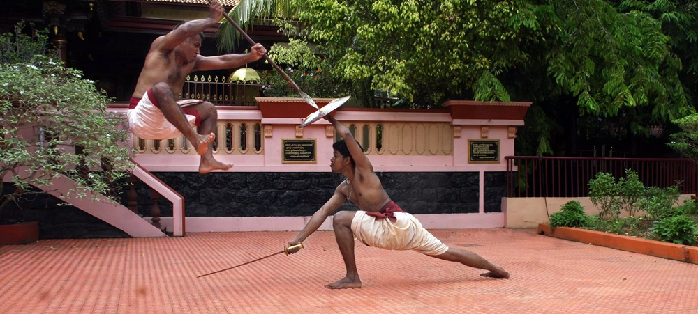 Two men using Kalaripayattu weapons 