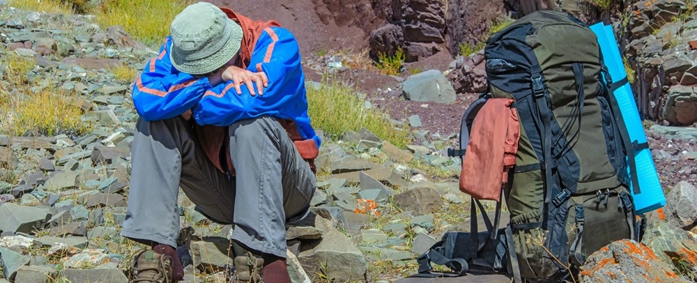 Man experiencing symptoms of altitude sickness