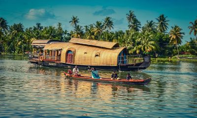 Kerala houseboat passing a canoe in its cruise