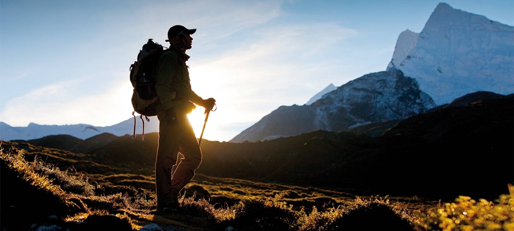 Man looking at the mountains while on a trek