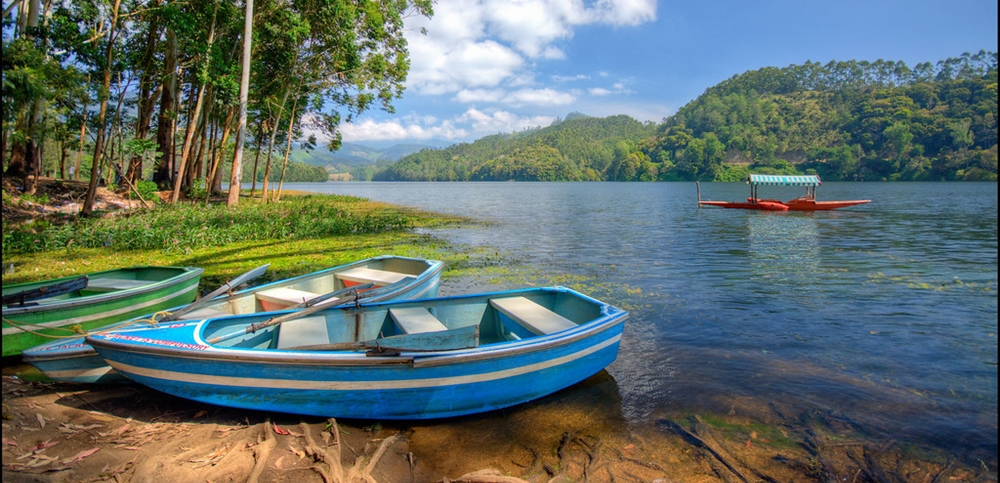 Colorful boats anchored at the shore of the Kundala Lake