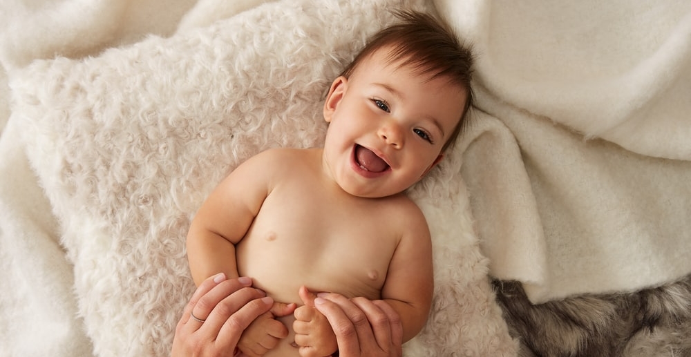 Newborn playing with the mother