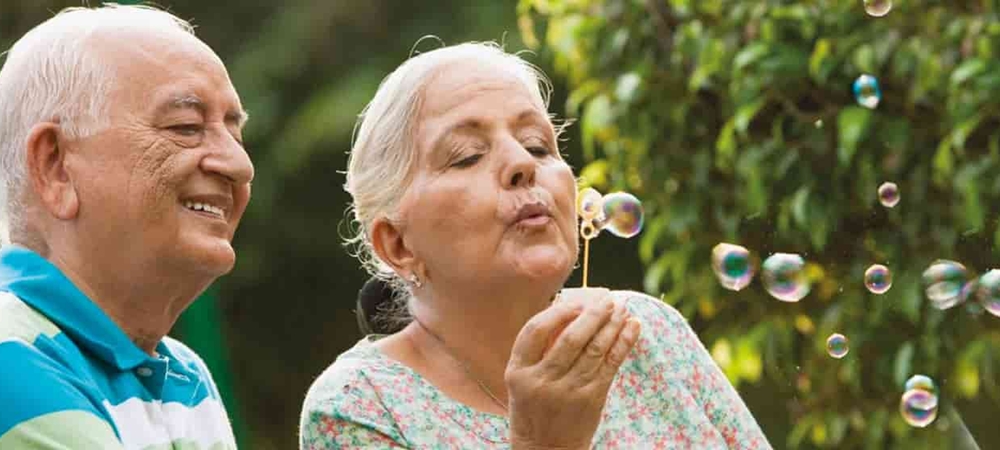 Elderly Couple playing with soap bubbles