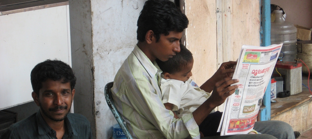 Young man reading newspaper