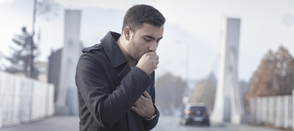 Man coughing on the road
