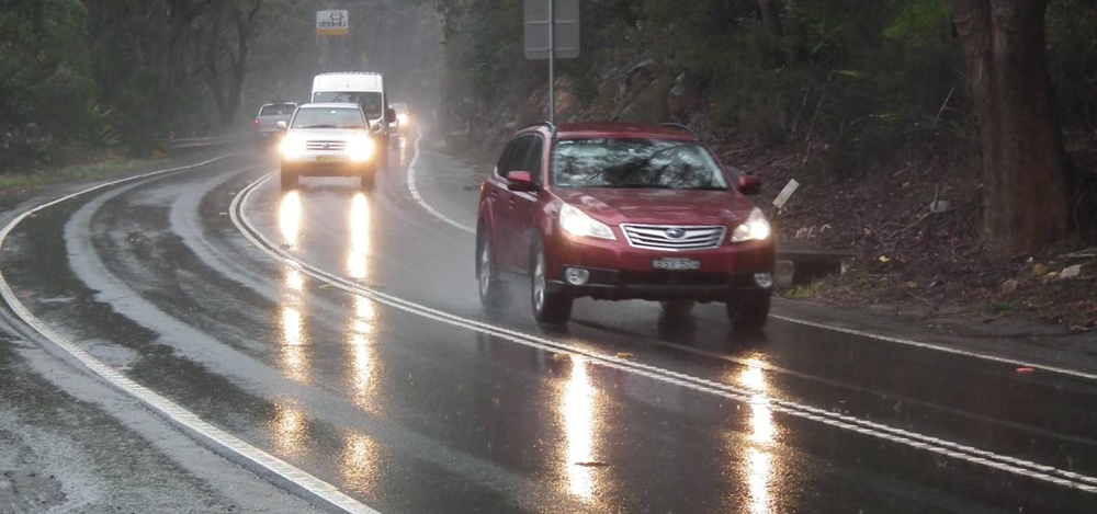 Cars with lights one while driving in the rain