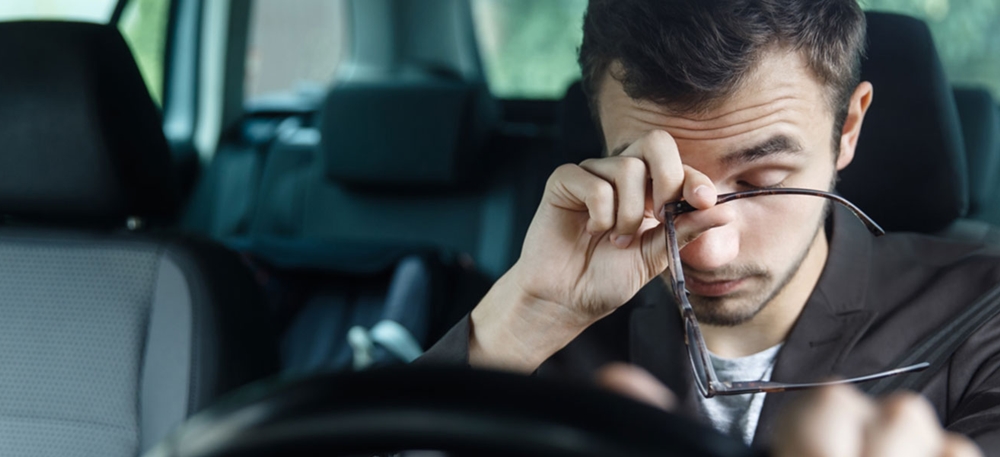 Man feeling drowsy while driving