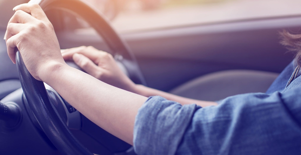 Both hands on the steering wheel