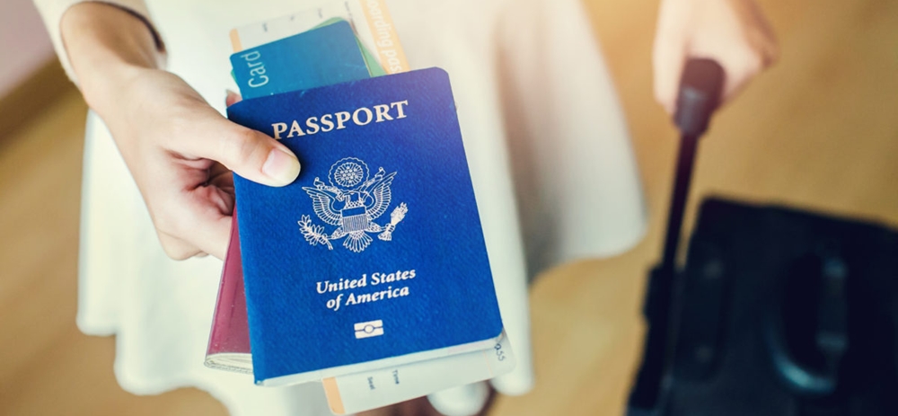 Woman holding passport and other documents