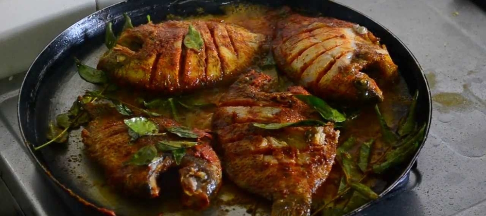 Karimeen marinated and frying on a pan