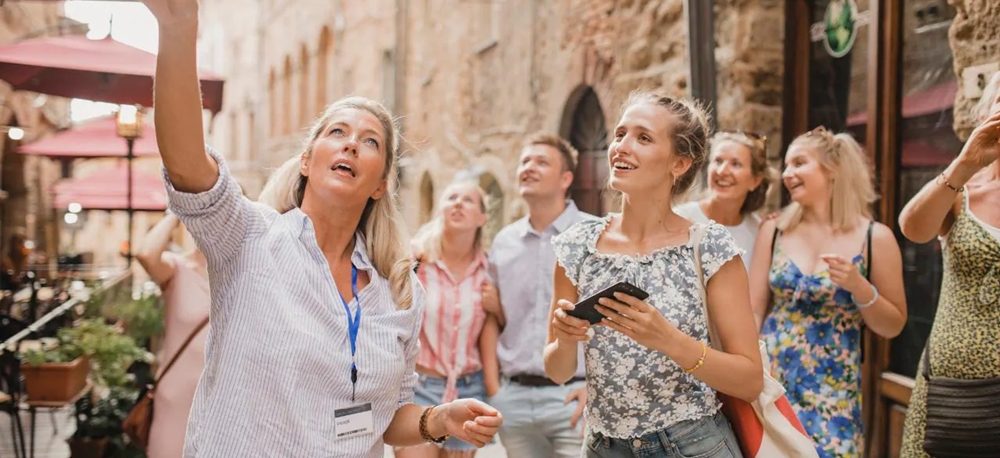 Tour guide showing a place to the tourists