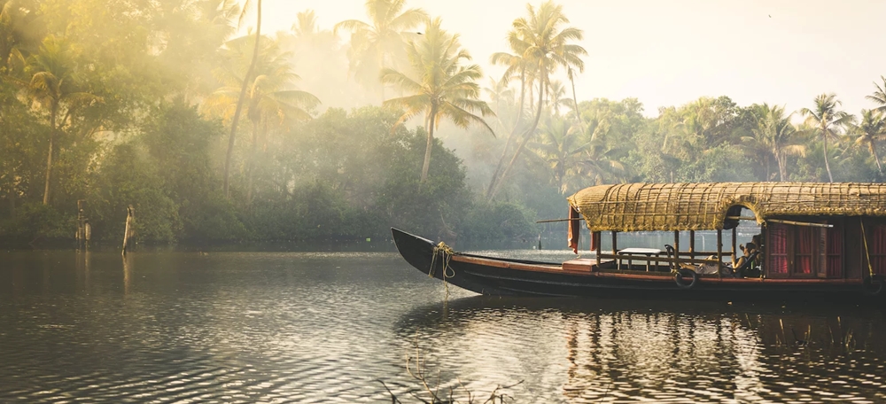 houseboat cruising through misty backwaters